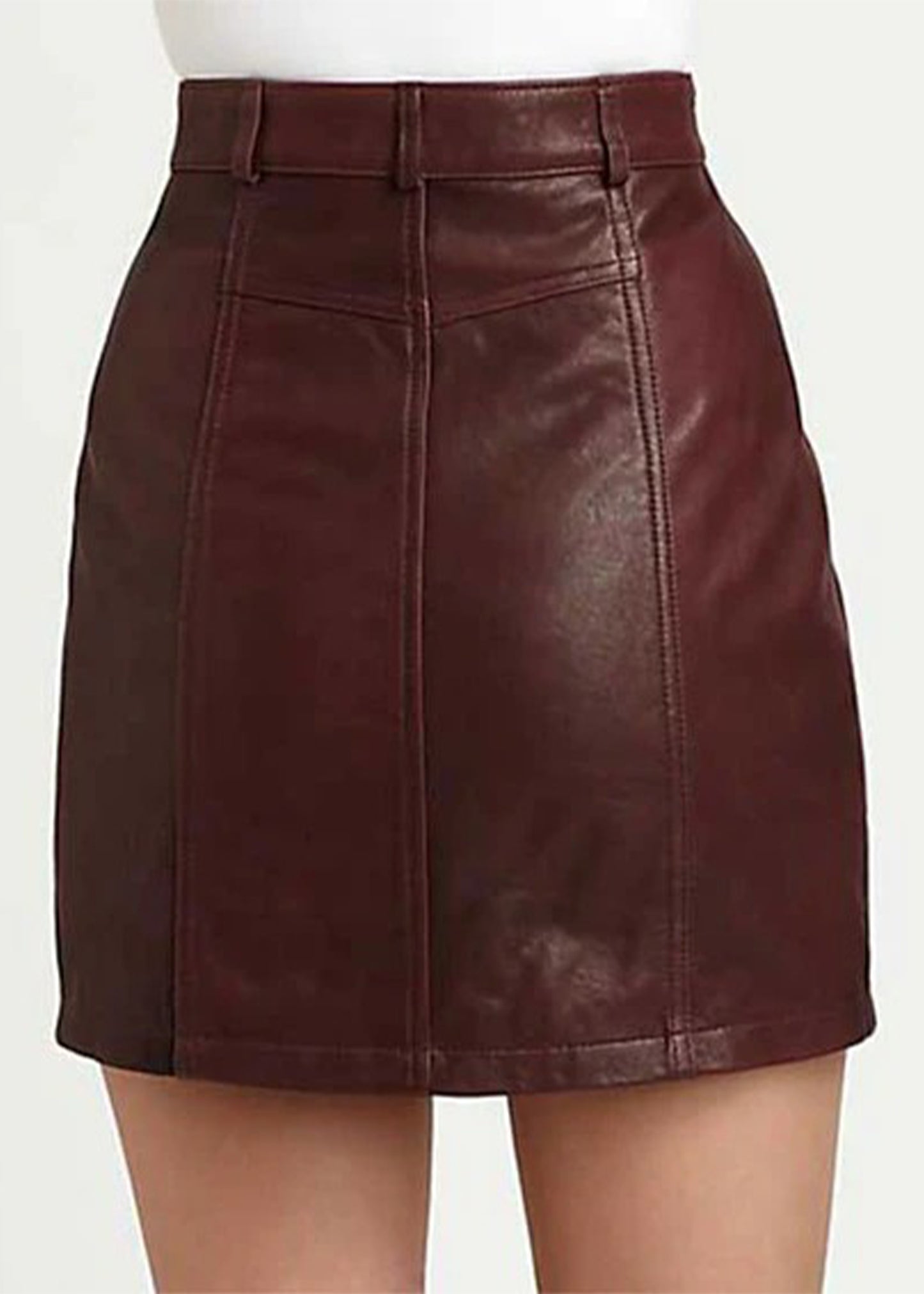 Brown leather skirt worn by a person on a white background