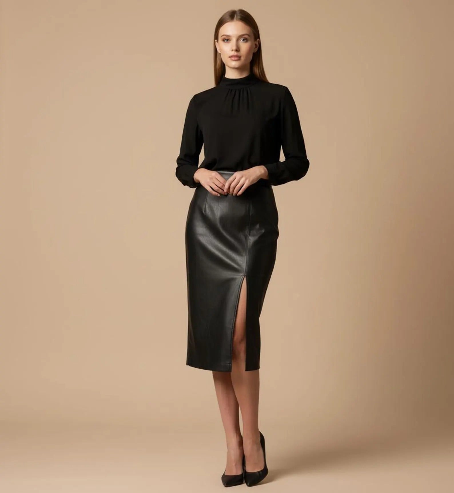 Woman wearing a black top and black leather skirt on a beige background