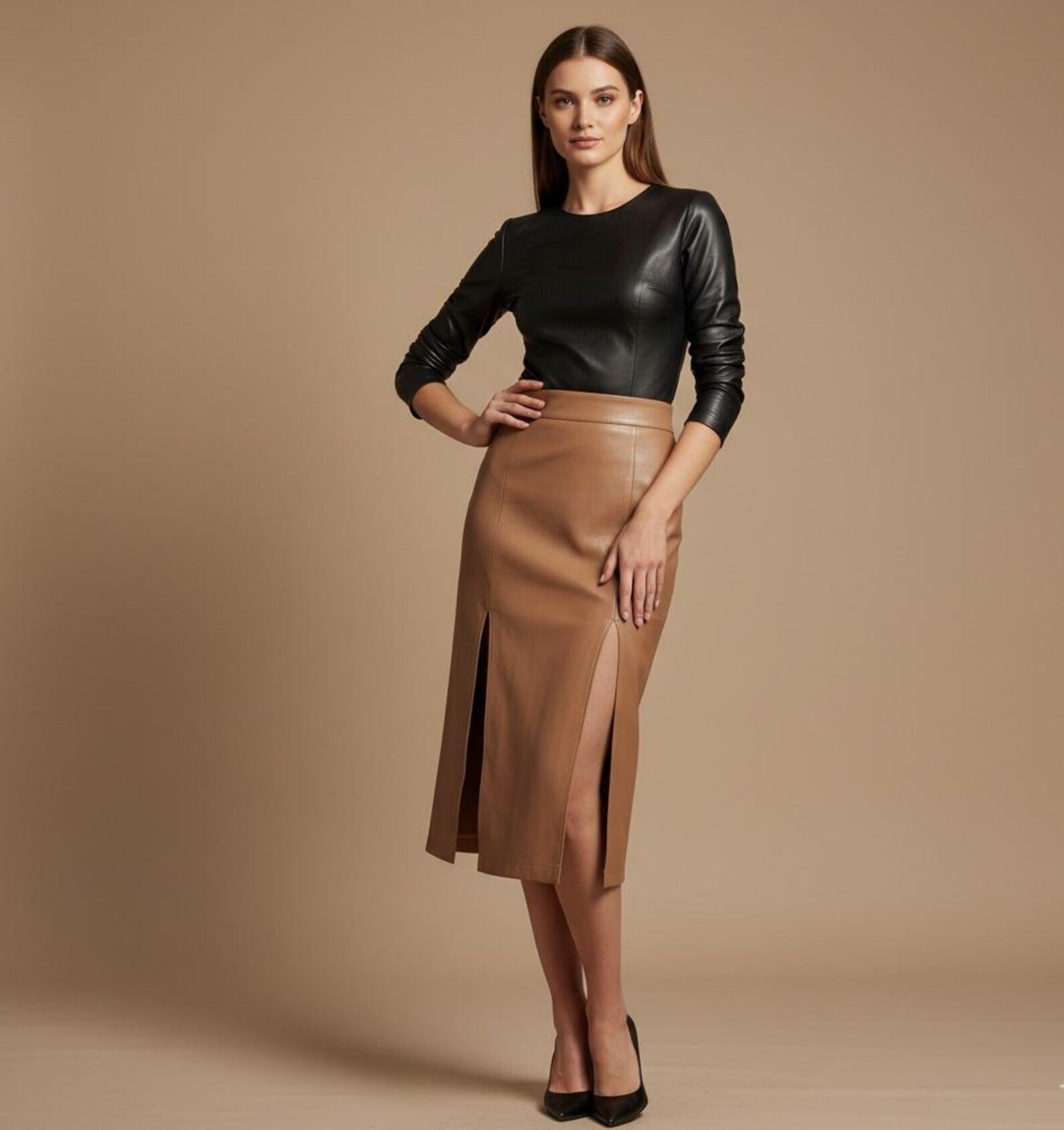 Woman wearing a black leather top and brown leather skirt on a beige background
