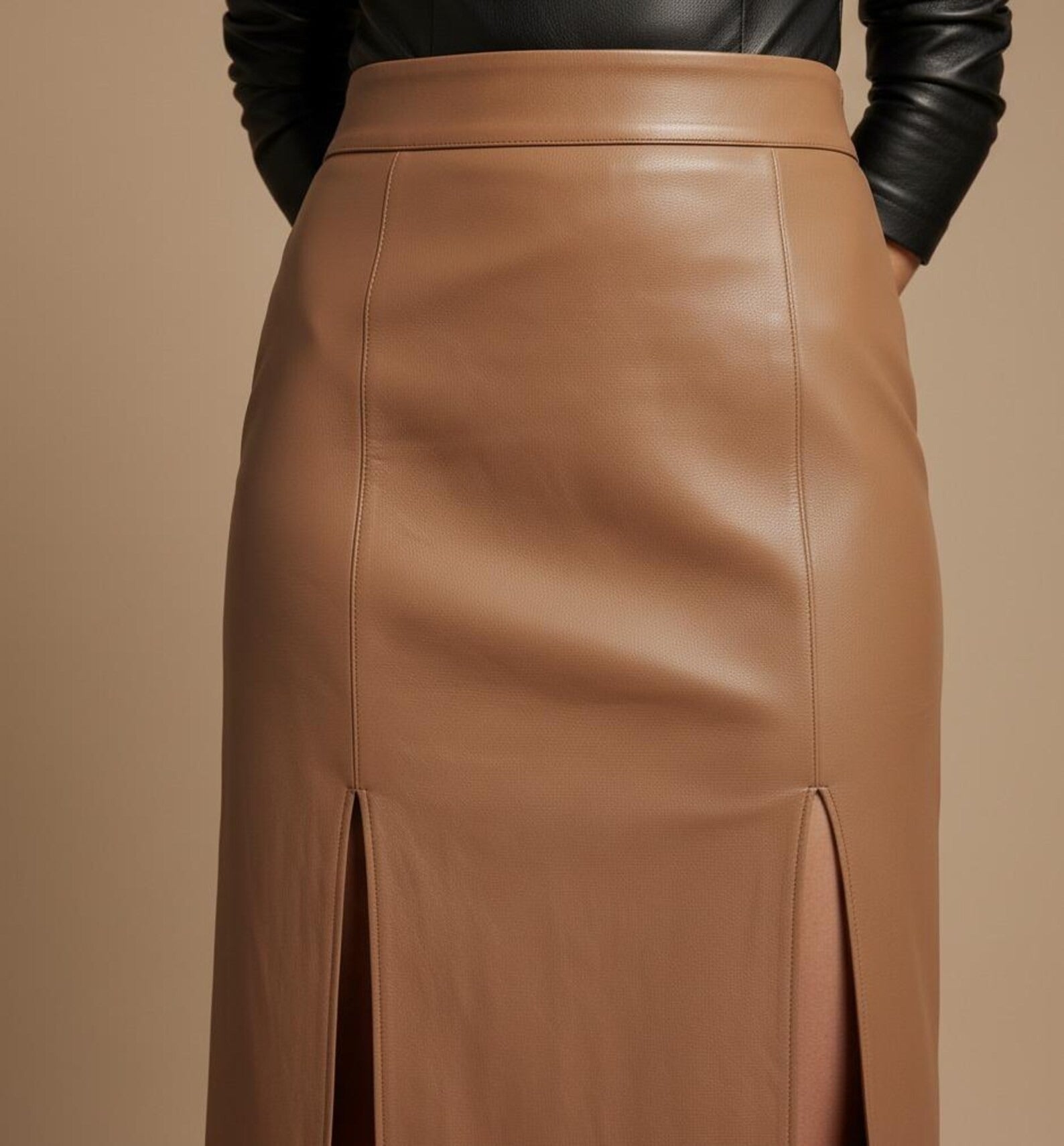 Brown leather skirt worn by a person on a beige background