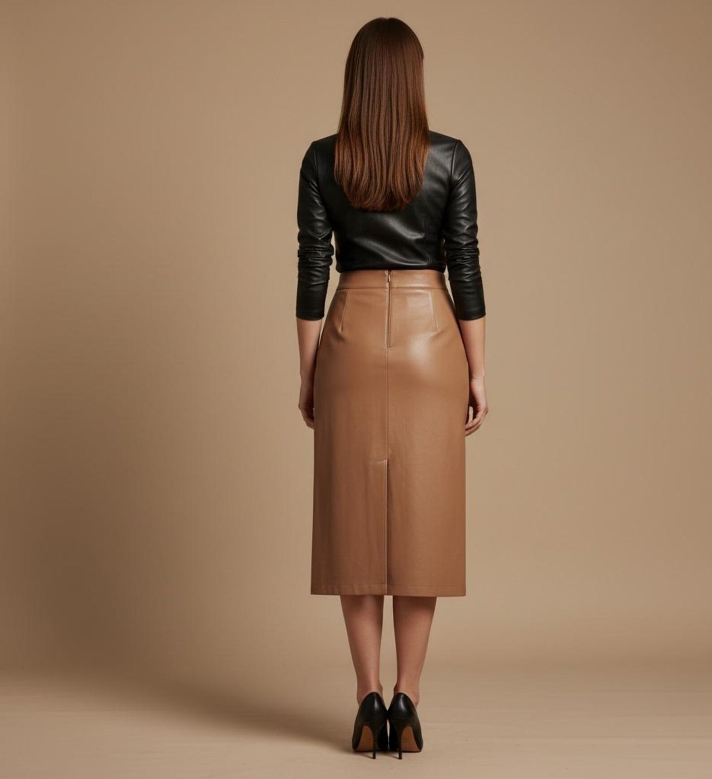 Woman wearing a brown leather skirt and tan leather skirt against a beige background