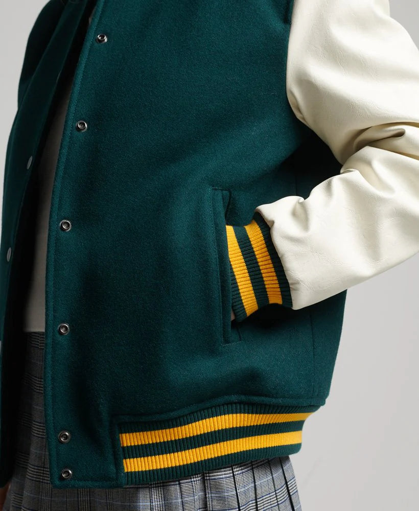 Green varsity jacket with yellow stripes on a plain background