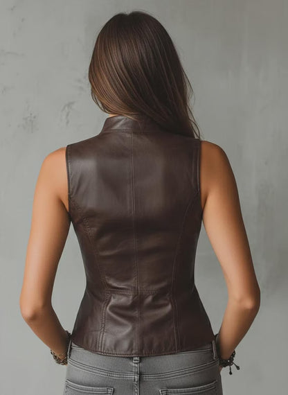 Person wearing a brown leather vest against a gray background