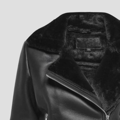 Black leather jacket with fur lining on a light gray background