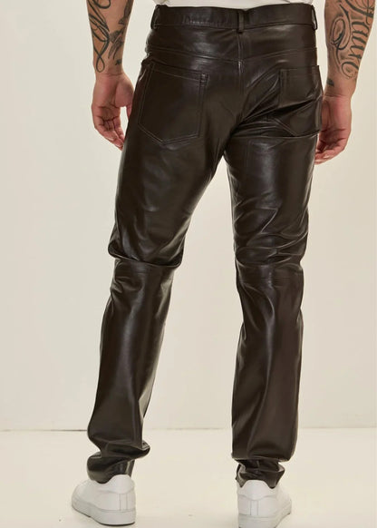 Person wearing black leather pants on a white background