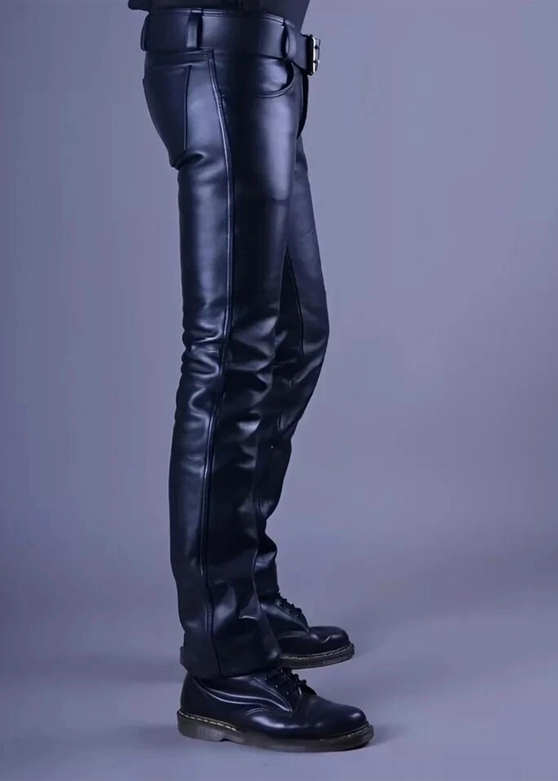 Black leather pants worn by a person on a gray background