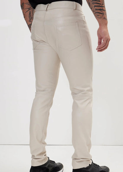 Beige pants worn by a person on a white background