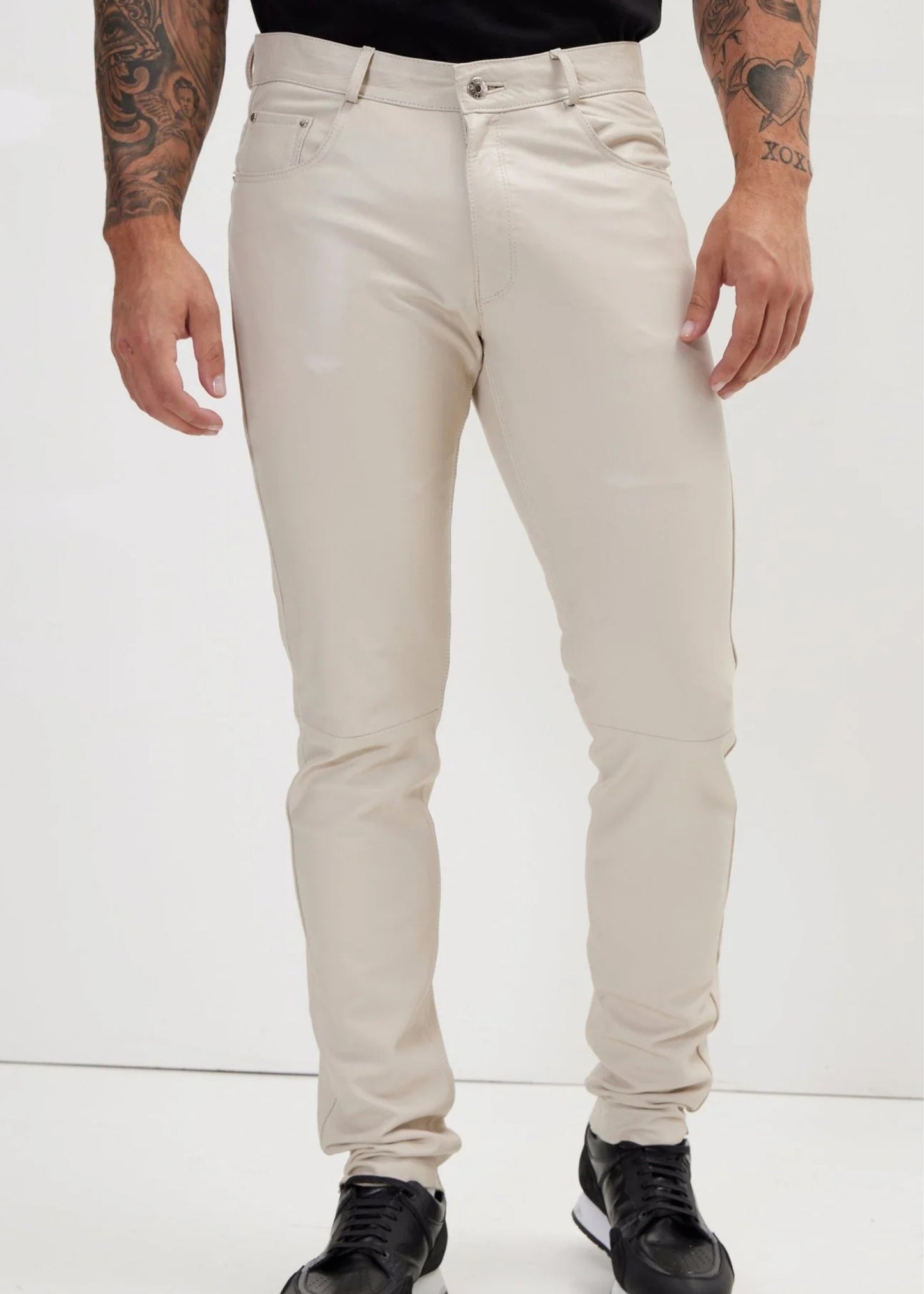 Person wearing beige pants on a white background