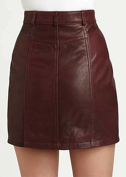 Brown leather skirt worn by a person on a white background