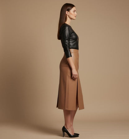 Woman wearing a black leather jacket and tan skirt on a beige background