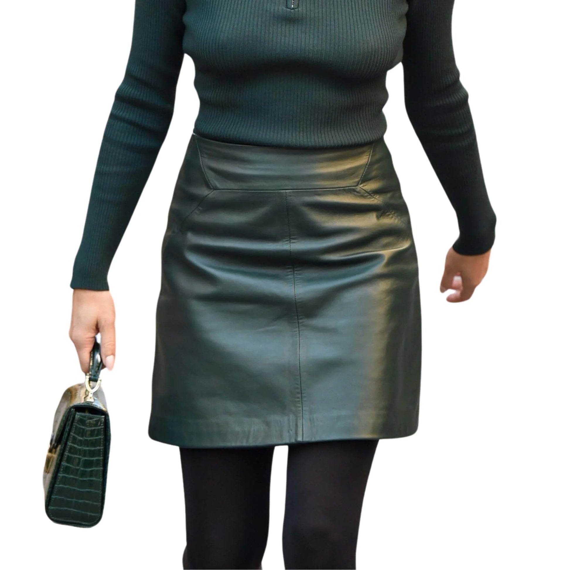 Person wearing a green leather skirt and black top on a white background