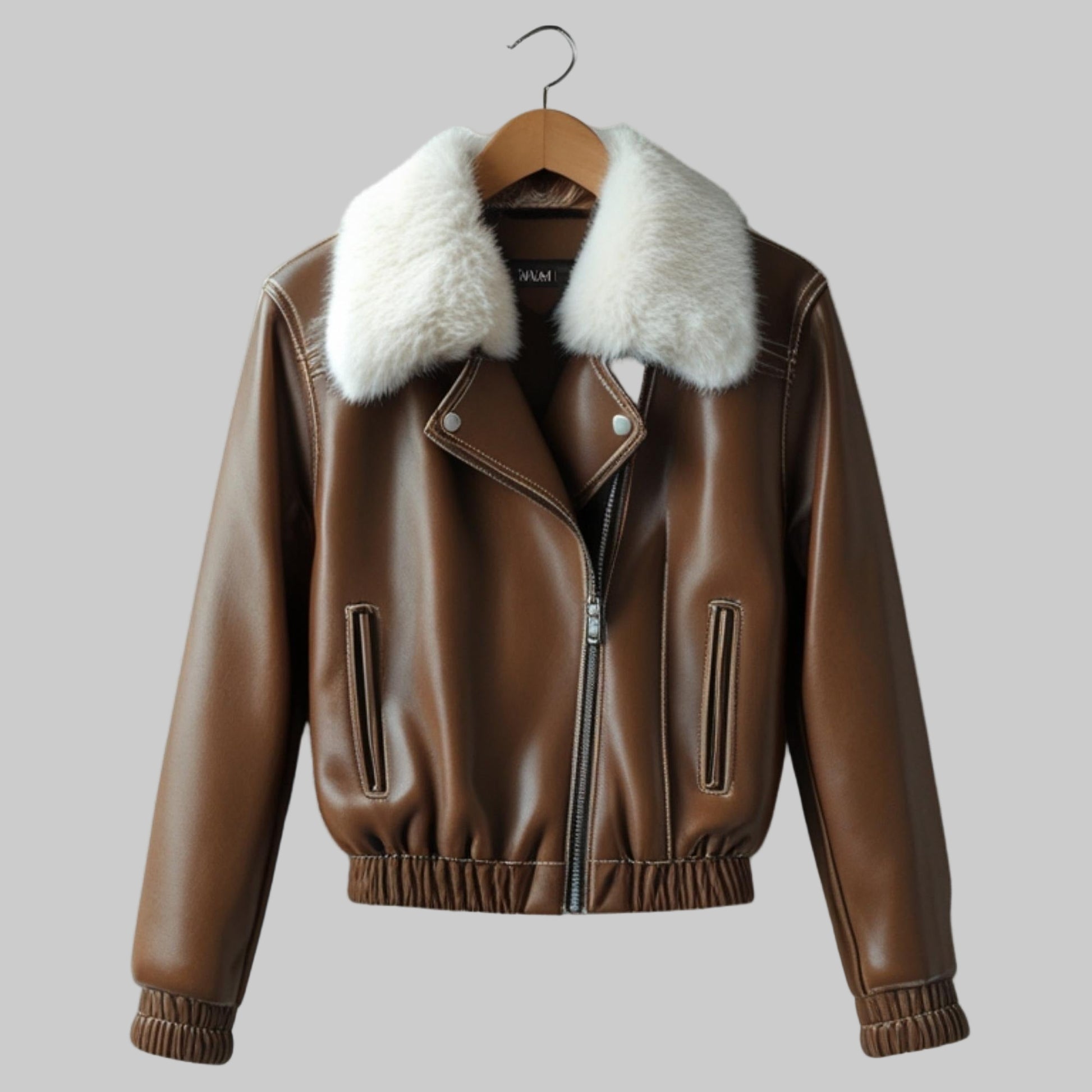 Brown leather jacket with white fur collar on a hanger against a light gray background