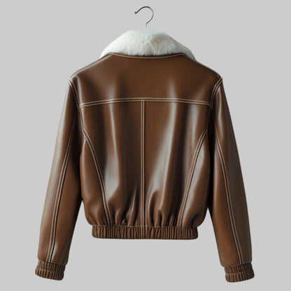 Brown leather jacket with white fur lining on a textured gray background