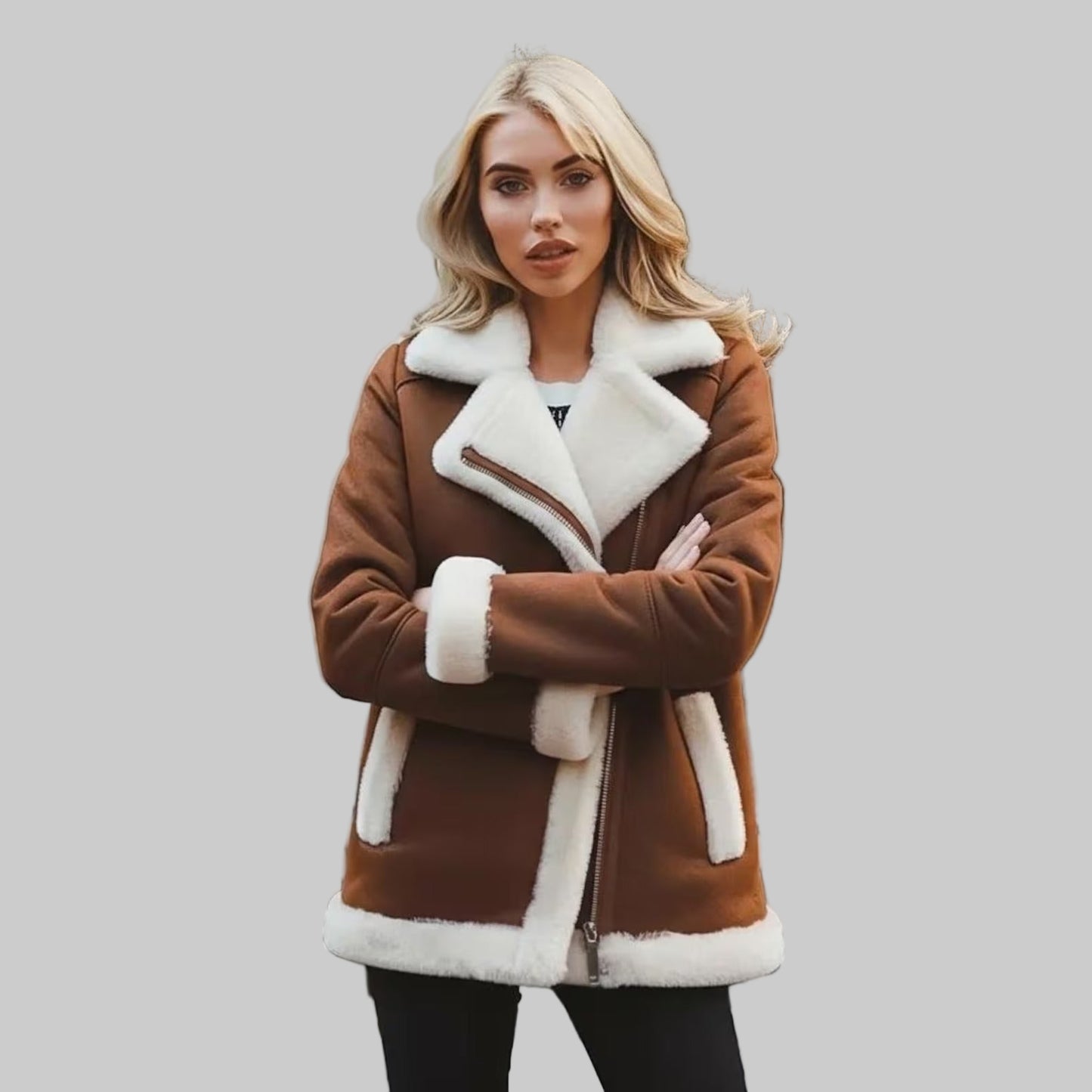 Woman wearing a brown coat with white fur trim standing on a checkered pavement.