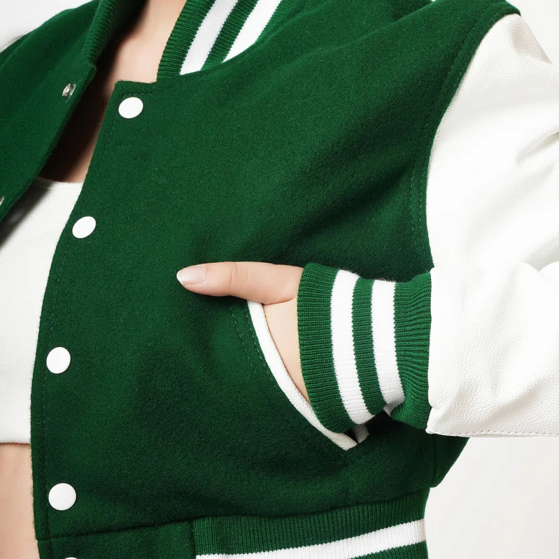 Green varsity jacket with white accents worn by a person