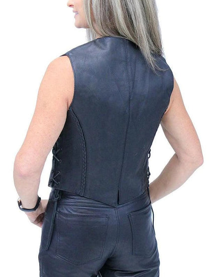 Person wearing a black leather vest on a white background