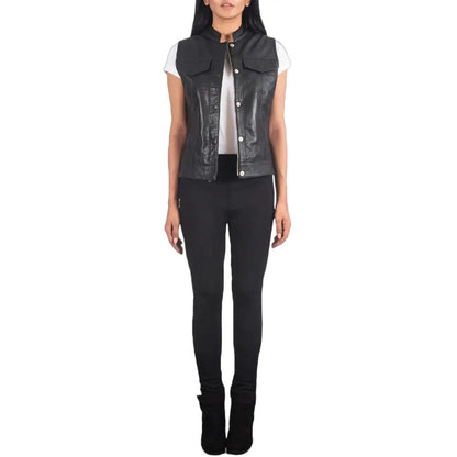 Person wearing a black leather vest over a white shirt on a white background